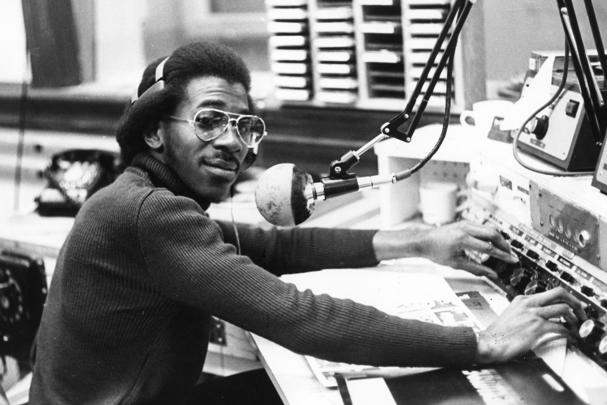 A student sits at a microphone