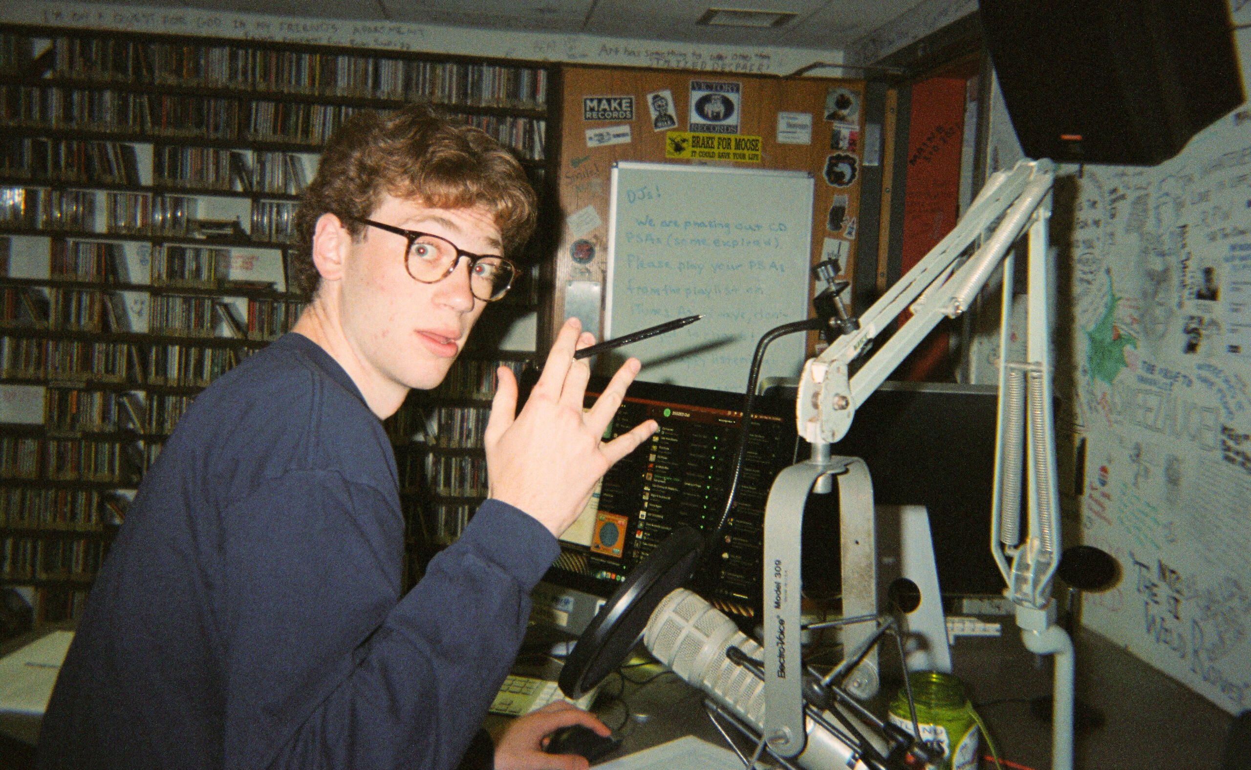 Student sitting at the broadcast studio microphone